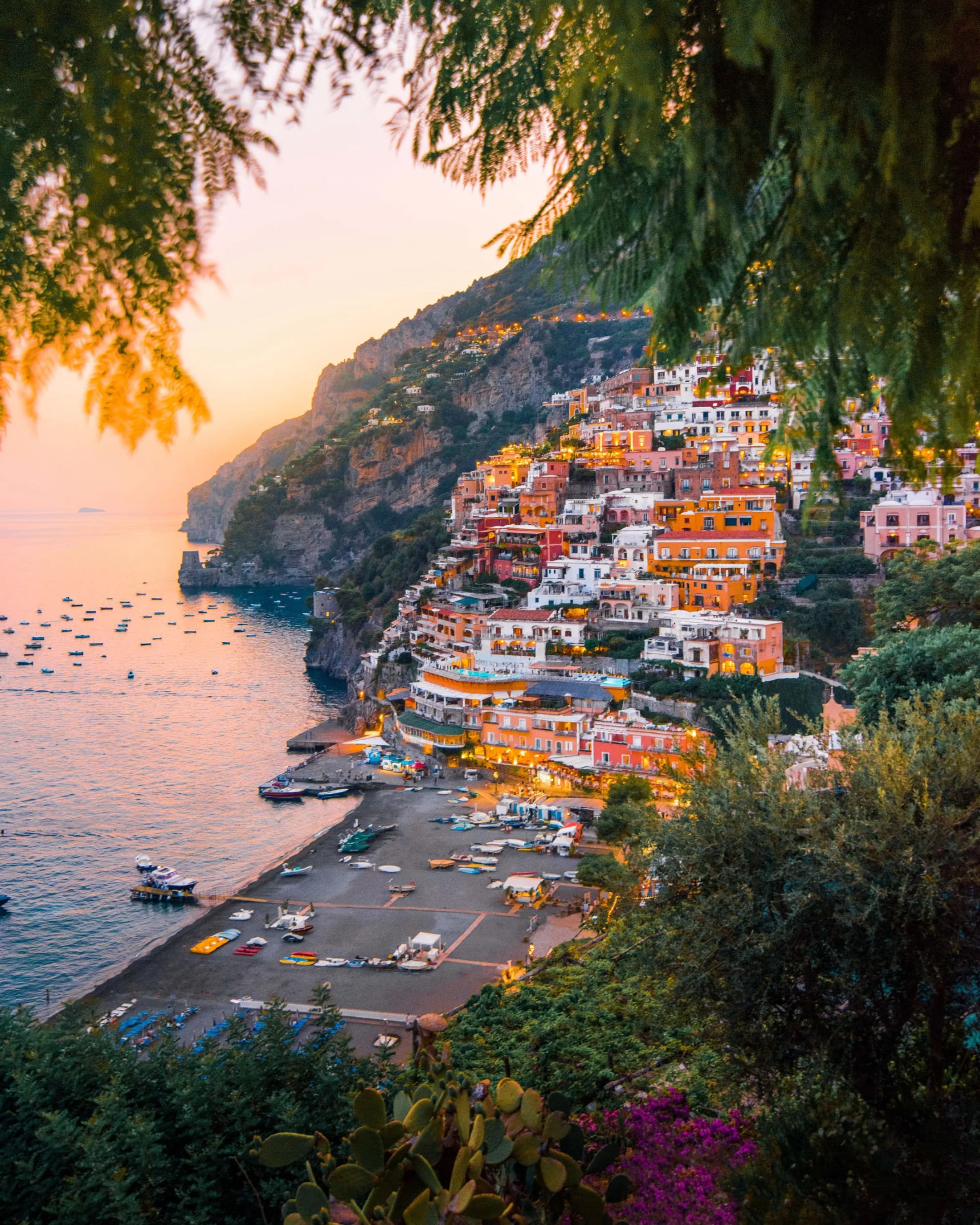 Positano's pastel houses stacked above the sea at golden hour