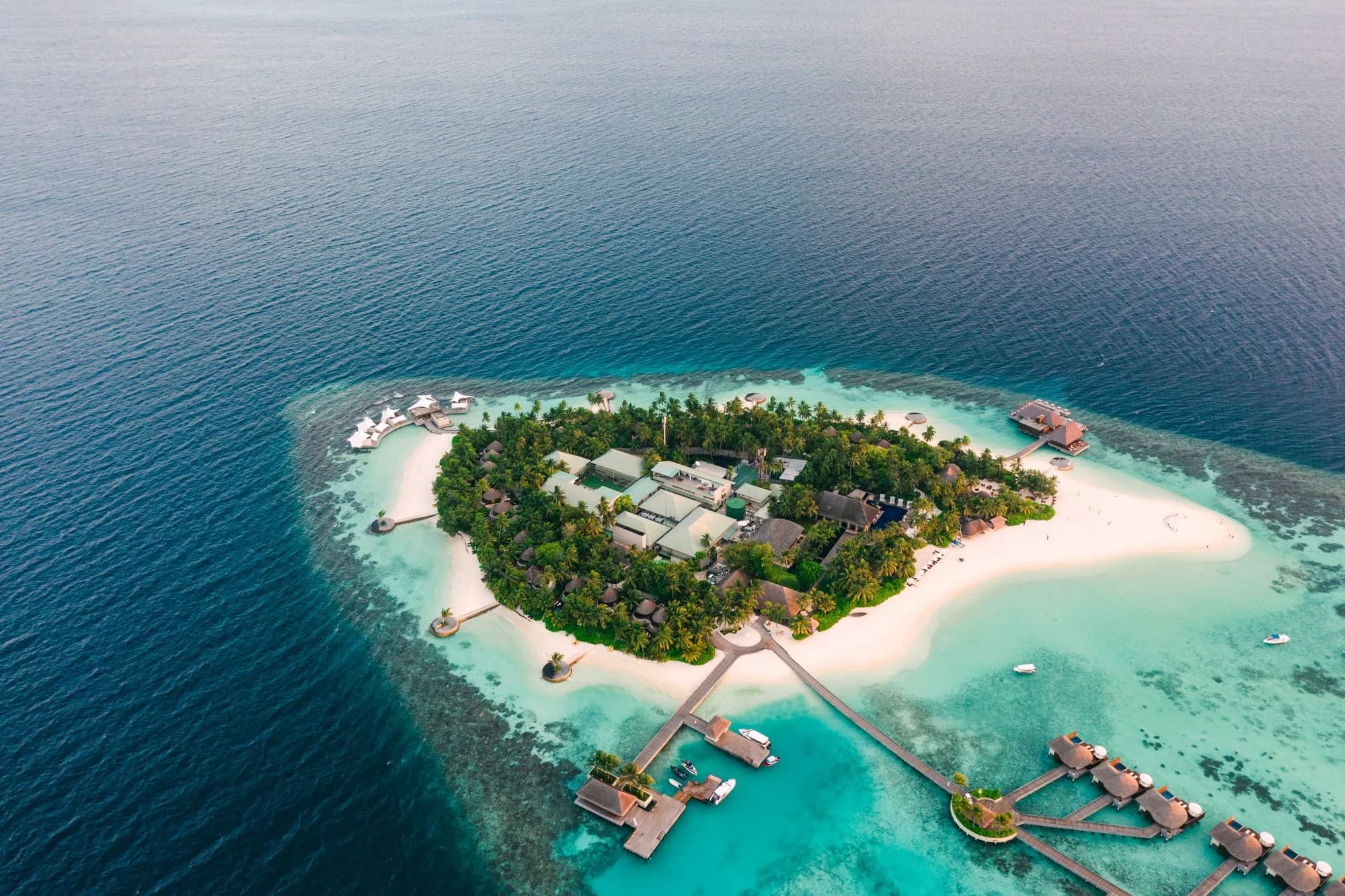 Aerial view of a private island resort surrounded by reef